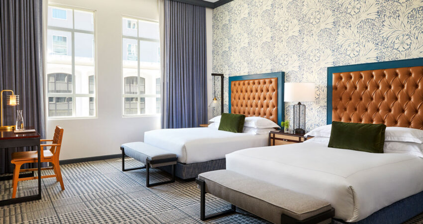 kimpton-denver-colorado-hotel-monaco-guestroom-double-queen-sleeping-room-desk-workspace-beds-3a04b121
